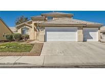 Charming stucco home featuring a three-car garage, tile roof, and low-maintenance landscaping at 3713 Ferrell St, North Las Vegas, NV 89032