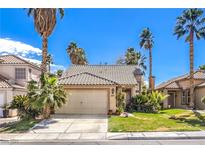 Charming single-story home featuring desert landscaping, a two-car garage, and a tile roof at 7211 Galley Dr, Las Vegas, NV 89147