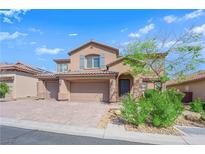 Attractive two-story home with a three car garage and desert landscaping at 7584 Sweet Mist Ave, Las Vegas, NV 89178