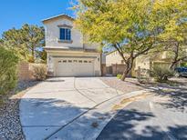 Two-story home featuring a two-car garage, neutral stucco and easy care landscaping at 8065 Starling View Ct, Las Vegas, NV 89166