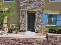 Charming home featuring a stone facade entry, modern lighting, and meticulously maintained landscaping at 965 Nevada State Dr # 8202, Henderson, NV 89002