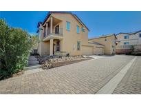 Charming home with a two-story exterior, balcony and a paved driveway on a sunny day at 971 Sable Chase Pl, Henderson, NV 89011