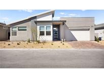 Contemporary home with a two-car garage, desert landscaping, and a modern design at 9815 Evergreen Pine St, Las Vegas, NV 89166