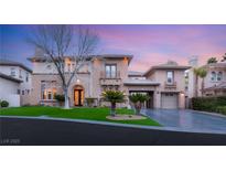 Elegant two-story home featuring well-manicured lawn and a spacious driveway at 10412 Mansion Hills Ave, Las Vegas, NV 89144