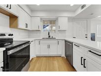 Updated kitchen with stainless steel appliances, white cabinets, and quartz countertops at 2725 S Nellis Blvd # 1033, Las Vegas, NV 89121