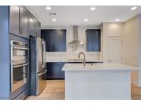 Modern kitchen features stainless steel appliances and a spacious island at 31 Castleton Tower Ct, Henderson, NV 89011