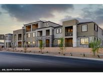 Modern townhome exterior with multiple balconies and neutral color palette, offering stylish curb appeal at 345 Ukelele Pl # Lot 153, Henderson, NV 89011