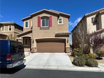 Inviting two-story home featuring a brown garage door and colorful red window shutters at 486 Stonegate Meadow Ave, Las Vegas, NV 89178