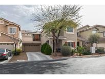 Charming two-story home with a landscaped front yard and a two-car garage at 10450 Kepler Cascades St, Las Vegas, NV 89141