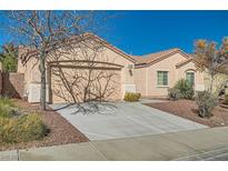 Charming single-story home featuring a two-car garage, low maintenance landscaping, and a tile roof at 1049 Desert Olive Ct, Henderson, NV 89002