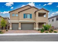 Charming two-story home featuring a 3-car garage, brick paver driveway, desert landscaping and an open air covered balcony at 3909 Grazing Gazelle Ave, North Las Vegas, NV 89084