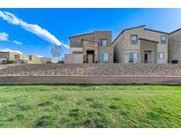 Contemporary two-story home boasting desert landscaping, stone accents, and a welcoming facade at 534 Lassen Falls Ct, Henderson, NV 89044