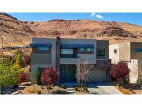Striking modern two-story home boasting a desert landscape, neutral tones, and a mountain backdrop at 6197 Jewel Vista St, Las Vegas, NV 89135