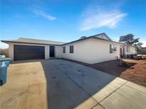 Charming single-story home featuring a two-car garage and a well-maintained front yard with desert landscaping at 6479 Gunderson Blvd, Las Vegas, NV 89103