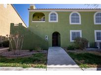 Charming two-story townhouse featuring an arched front door, arched windows, and a well-maintained walkway at 7950 W Flamingo Rd # 1173, Las Vegas, NV 89147
