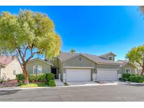 Charming home featuring a two-car garage, lush landscaping, and a well-maintained lawn at 10924 Bandol Pl, Las Vegas, NV 89141