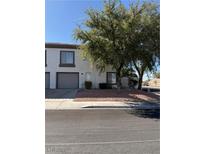 Charming townhome featuring a well-maintained lawn and a neutral color palette at 221 Oro Canyon St, Henderson, NV 89074