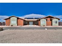 Charming single-story home with xeriscaping, solar panels, and unique architectural style at 2330 Deadwood St, Pahrump, NV 89048