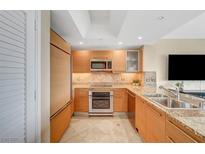 Modern kitchen with stainless steel appliances, granite countertops and tile flooring at 322 Karen Ave # 703, Las Vegas, NV 89109