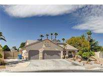 Charming single-story home featuring a three-car garage and desert landscaping with palm trees at 6513 Echo Crest Ave, Las Vegas, NV 89130