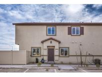 Beige two-story home featuring a traditional facade, neutral trim and small front yard at 7890 Pandora Sky St # 253, North Las Vegas, NV 89084