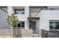 Modern townhome featuring stucco exterior, gated entry, and well-maintained landscaping at 1452 Melodic Lark Ln, Las Vegas, NV 89138