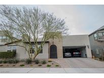Charming single-story home featuring a brick driveway, arched doorway, and a convenient two-car garage at 1608 Rock Ridge Pl, North Las Vegas, NV 89084