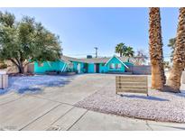 Charming single story home with a bright exterior, desert landscaping, and a large driveway at 1700 Ivanhoe Way, Las Vegas, NV 89102