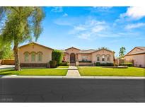 Charming single-story home featuring a well-manicured lawn, desert landscaping and beautiful architecture at 215 Great Gable Dr, Las Vegas, NV 89183