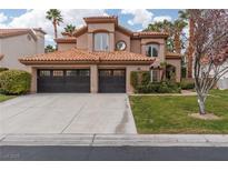 Charming two-story stucco home featuring a tile roof, a well-maintained lawn, and a two-car garage at 2313 Timberline Way, Las Vegas, NV 89117