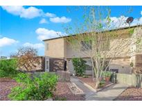 Charming two-story townhome with well-maintained landscaping and inviting curb appeal under a bright, partly cloudy sky at 241 E Van Wagenen St, Henderson, NV 89015