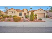 Charming single-story home with well-manicured landscaping, rocks and a terracotta roof at 2585 Portsmouth Creek Ave, Henderson, NV 89052