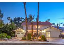 Charming two-story home features manicured landscaping, a garage, and a welcoming entrance with mature palm trees at 3341 Heavenly View Ct, Las Vegas, NV 89117