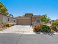 Charming single-story home with a two-car garage and desert landscaping for low maintenance at 4016 Balsam Mountain St, Las Vegas, NV 89129