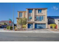 A modern two-story home with a three car garage, desert landscaping, and neutral color palette at 5946 Ancient Peaks Ave, Las Vegas, NV 89141