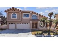 Two-story home featuring a three-car garage, well-maintained landscaping, and a classic tile roof at 7425 Enchanted Hills Ct, Las Vegas, NV 89129