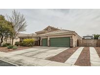 Single-story home featuring a three-car garage, tile roof, desert landscaping, and RV parking at 7690 Blue Whirlpool St, Las Vegas, NV 89131