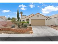 Charming single-story home featuring a two-car garage, desert landscaping, and a classic tiled roof at 7817 Wind Drift Rd, Las Vegas, NV 89149
