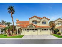 Charming two-story home featuring a three-car garage, desert landscaping, and a classic red tile roof at 8132 Bay Harbor Dr, Las Vegas, NV 89128