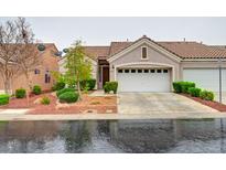 Charming single-story home featuring a two-car garage and manicured landscaping at 9677 Emeraude Ave, Las Vegas, NV 89147