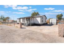 Charming single-story home with a gravel driveway and fenced yard, offering a cozy and private living space at , Las Vegas, NV 89156