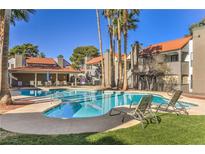 Inviting community pool area with lounge chairs, shaded seating, and well-maintained landscaping on a sunny day at 3411 Sunfish Dr # B, Henderson, NV 89014
