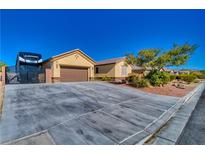 Charming home featuring a spacious driveway, RV parking, and a well-maintained front yard at 3854 E Chaffe Ave, Pahrump, NV 89061