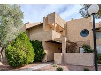 Inviting condo featuring a unique facade, covered entry, and mature landscaping at 3949 S Torrey Pines Dr, Las Vegas, NV 89103