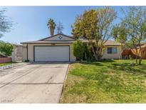 Charming single-story home featuring a well-maintained lawn and an attached two-car garage at 4639 Mountain Vista St, Las Vegas, NV 89121