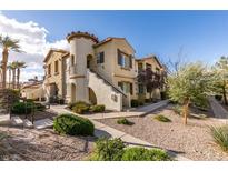 Charming townhome with unique architectural details, including a turret and landscaped front yard at 50 Aura De Blanco St # 19203, Henderson, NV 89074