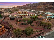 Stunning hillside home with tile roof, balconies, lush landscaping, and an in-ground pool overlooking desert mountains at 503 Aaron Way, Boulder City, NV 89005