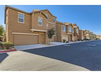 Charming street view of modern townhomes featuring attached garages and well-maintained landscaping at 5179 Silica Chalk Ave, Las Vegas, NV 89115