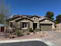 Charming single-story home with desert landscaping, a brick driveway, and solar panels for energy efficiency at 5604 Felicity Cir, Las Vegas, NV 89139