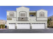 Inviting condo building with three garage doors and neutral color scheme, offering convenient parking at 6328 Desert Leaf St # 102, North Las Vegas, NV 89081
